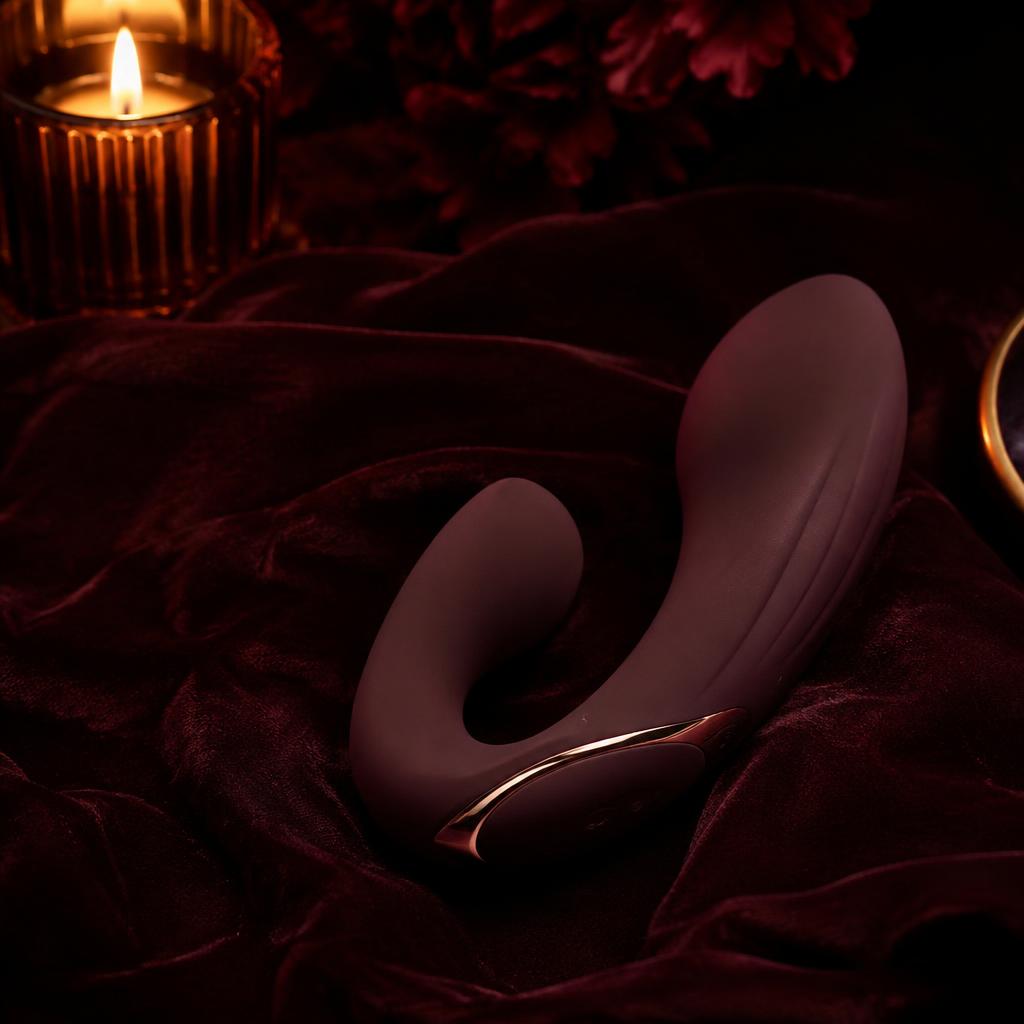 Sculptural plum couples vibrator on dark velvet